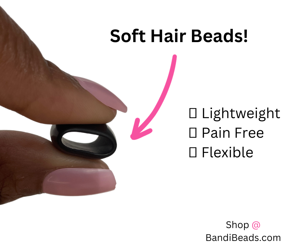 Squishy Silicone Rubber Hair Beads in the color black. Female hands pressing hair bead between two fingers