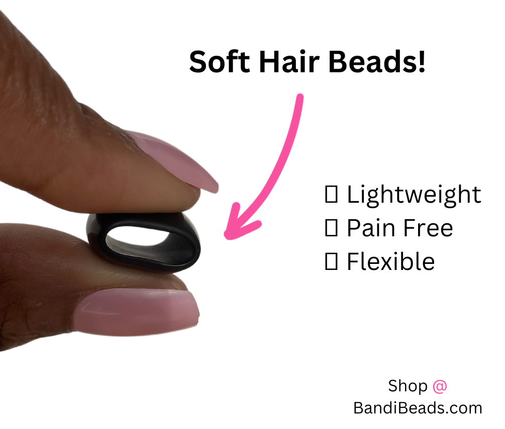 black silicone hair bead squished between two fingers to show the squishy hair beads are soft hair beads and lightweight